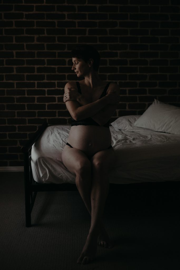 naked pregnant woman on bed