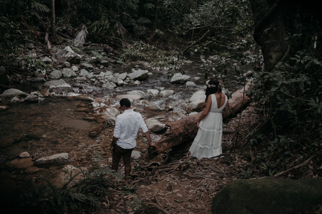 bride and groom walking in forest cougar cascades currumbin