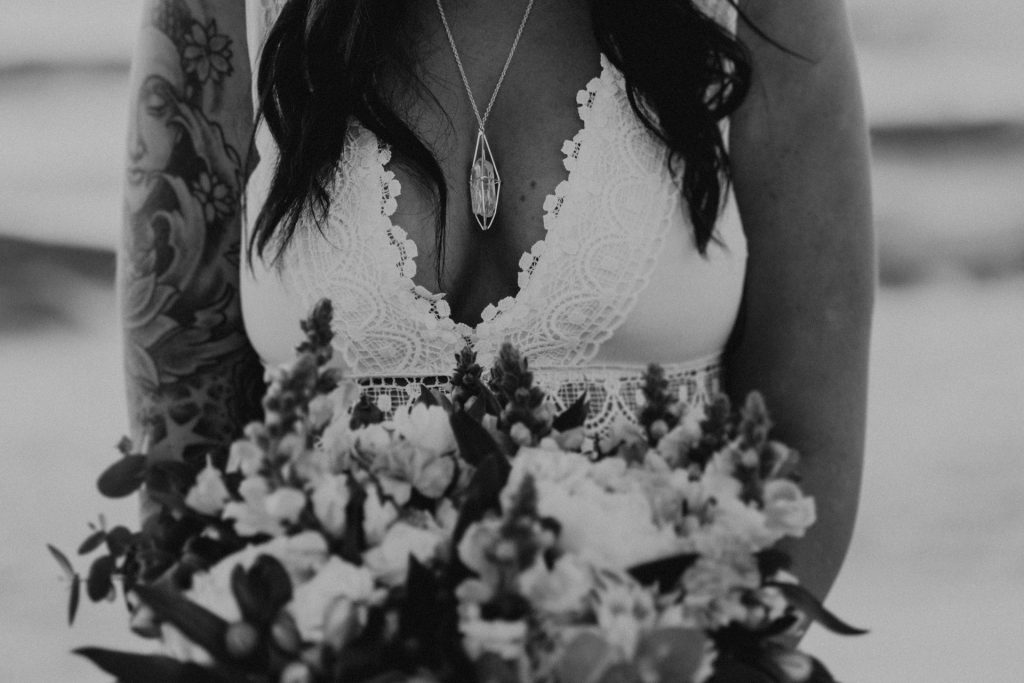 bride holding flowers lace dress pendant breasts