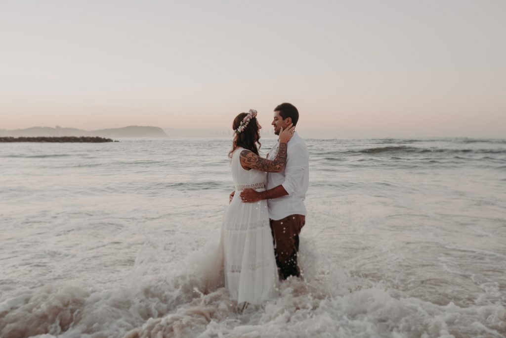 bride and groom standing in ocean flower crown sunset Currumbin gold coast