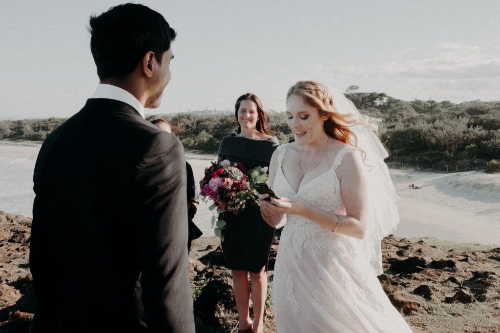 ceremony on windy cliff Fingal head bride in pink dress