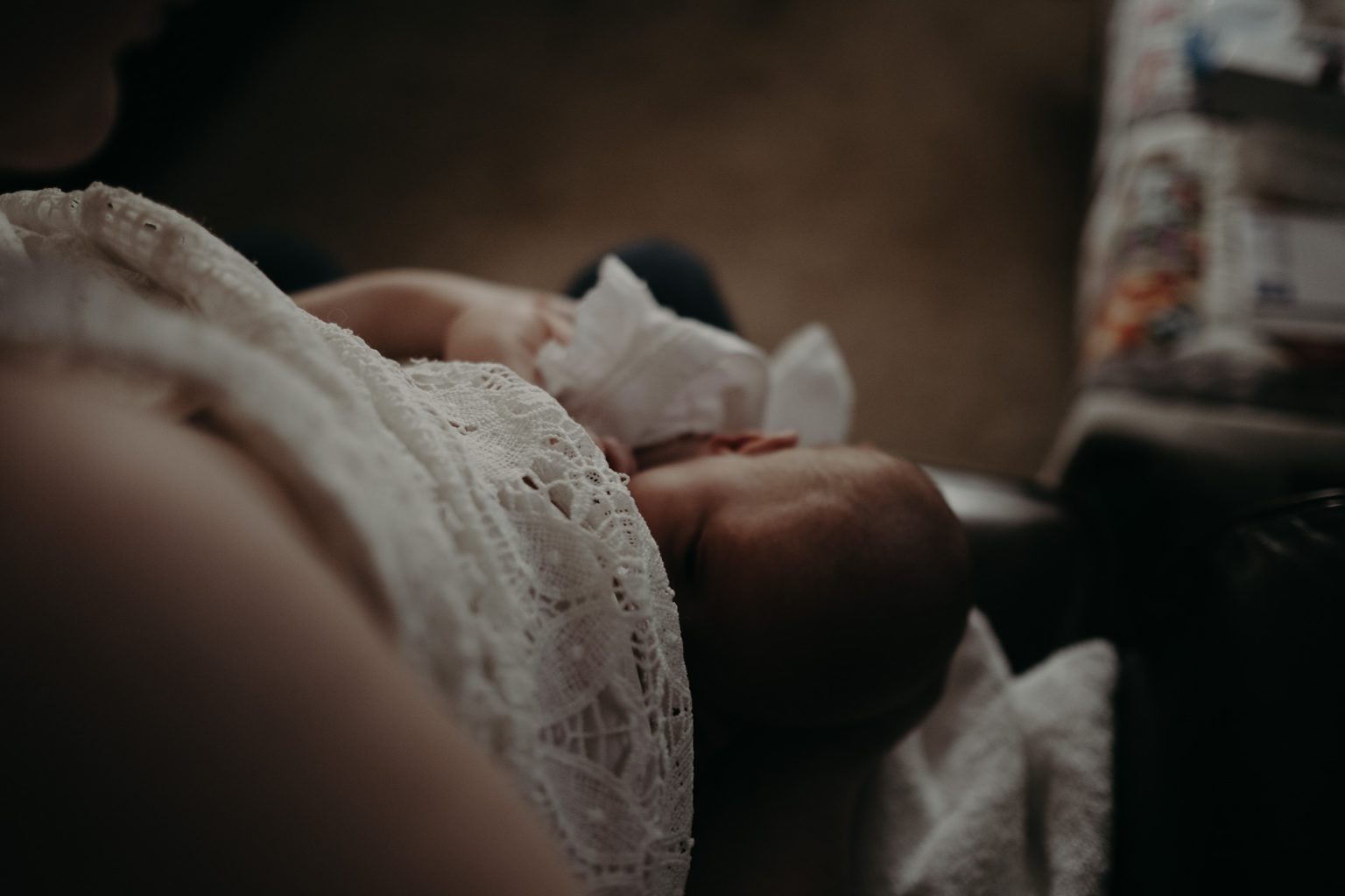 woman breastfeeding newborn lace