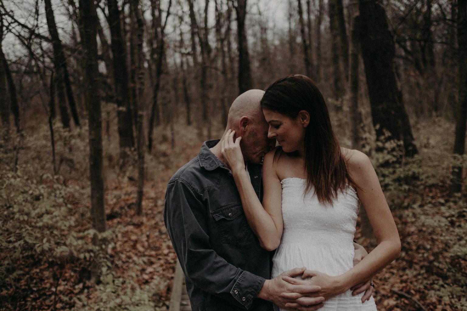 man pregnant woman woods forest illinois hugging