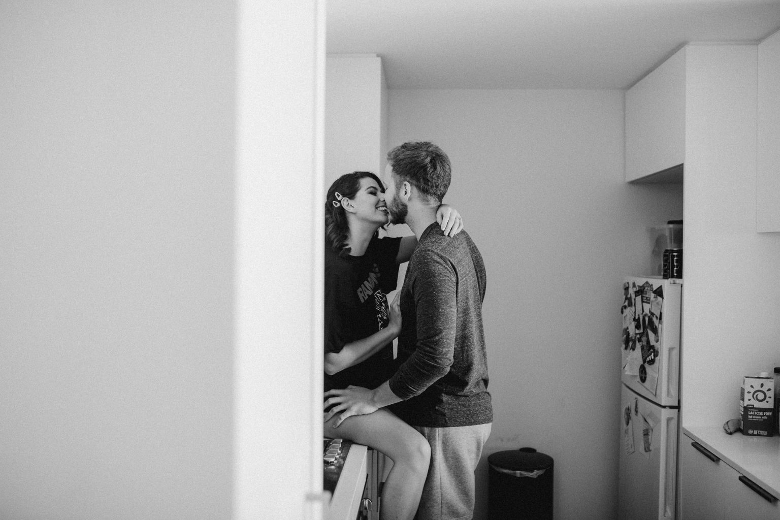 Man and woman kissing in kitchen 