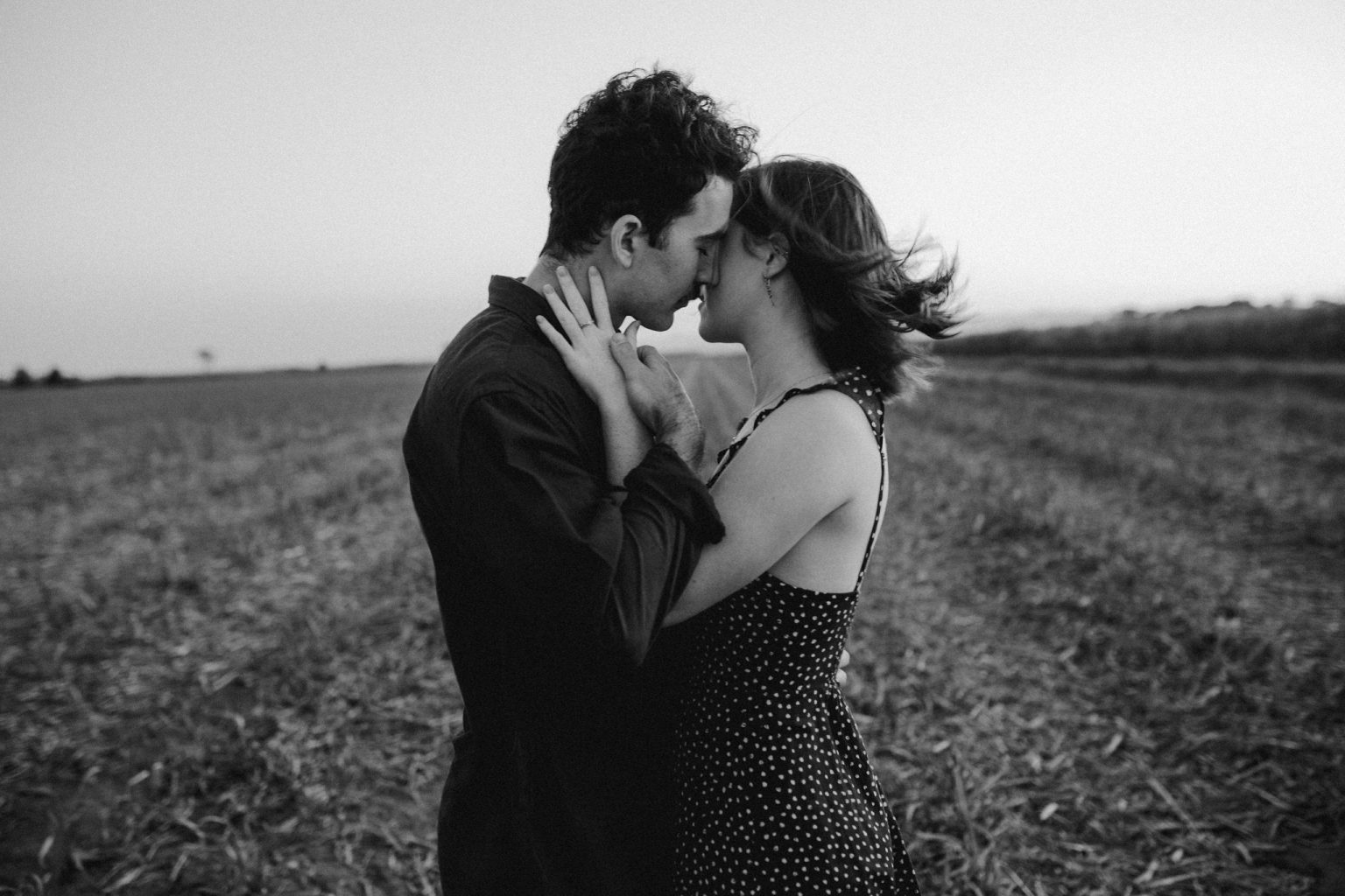 Man and woman hugging in field sexy