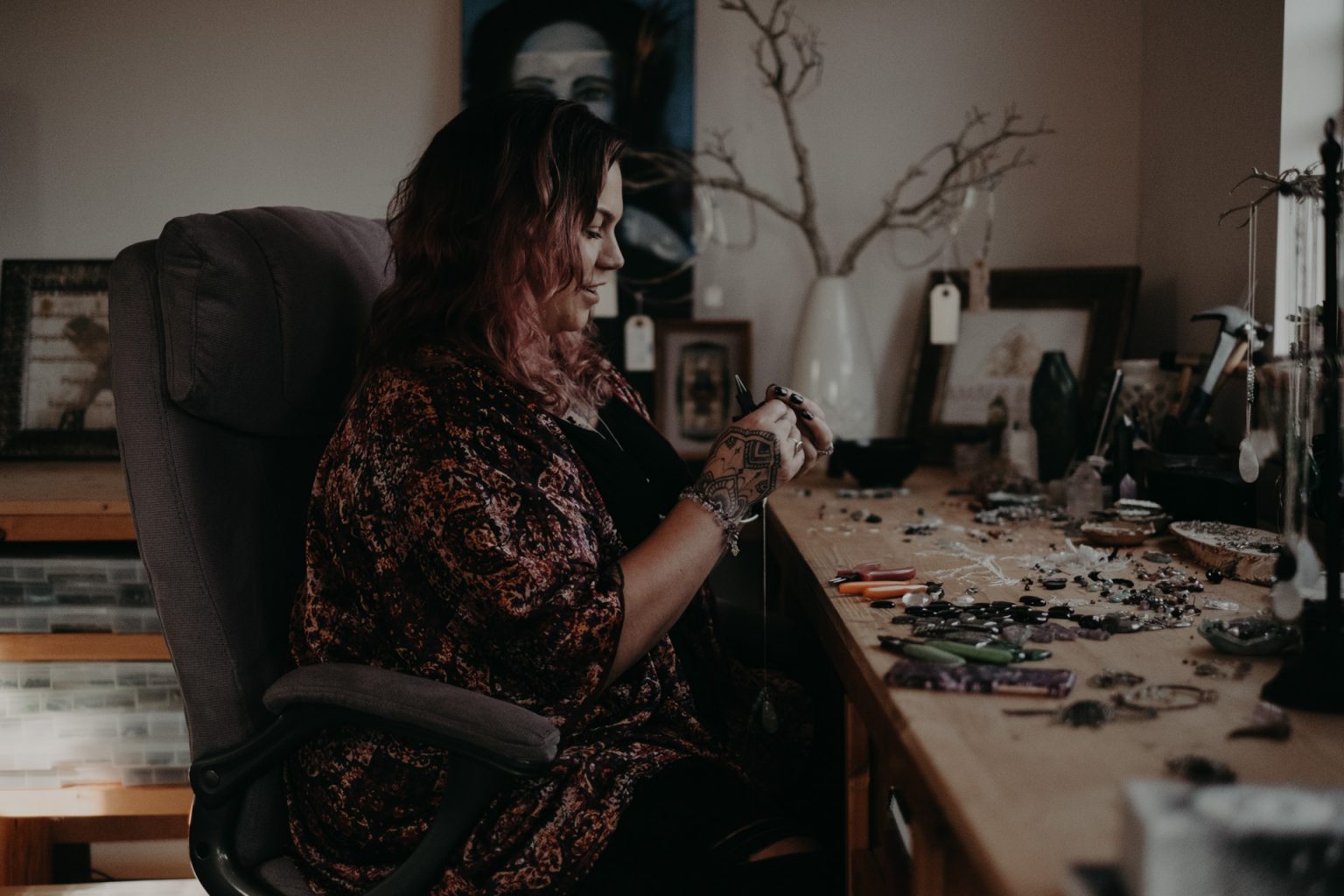 woman making jewellery at table 