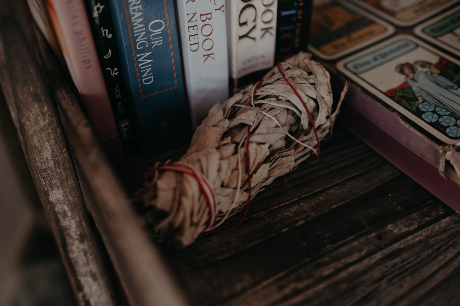 sage stick near books