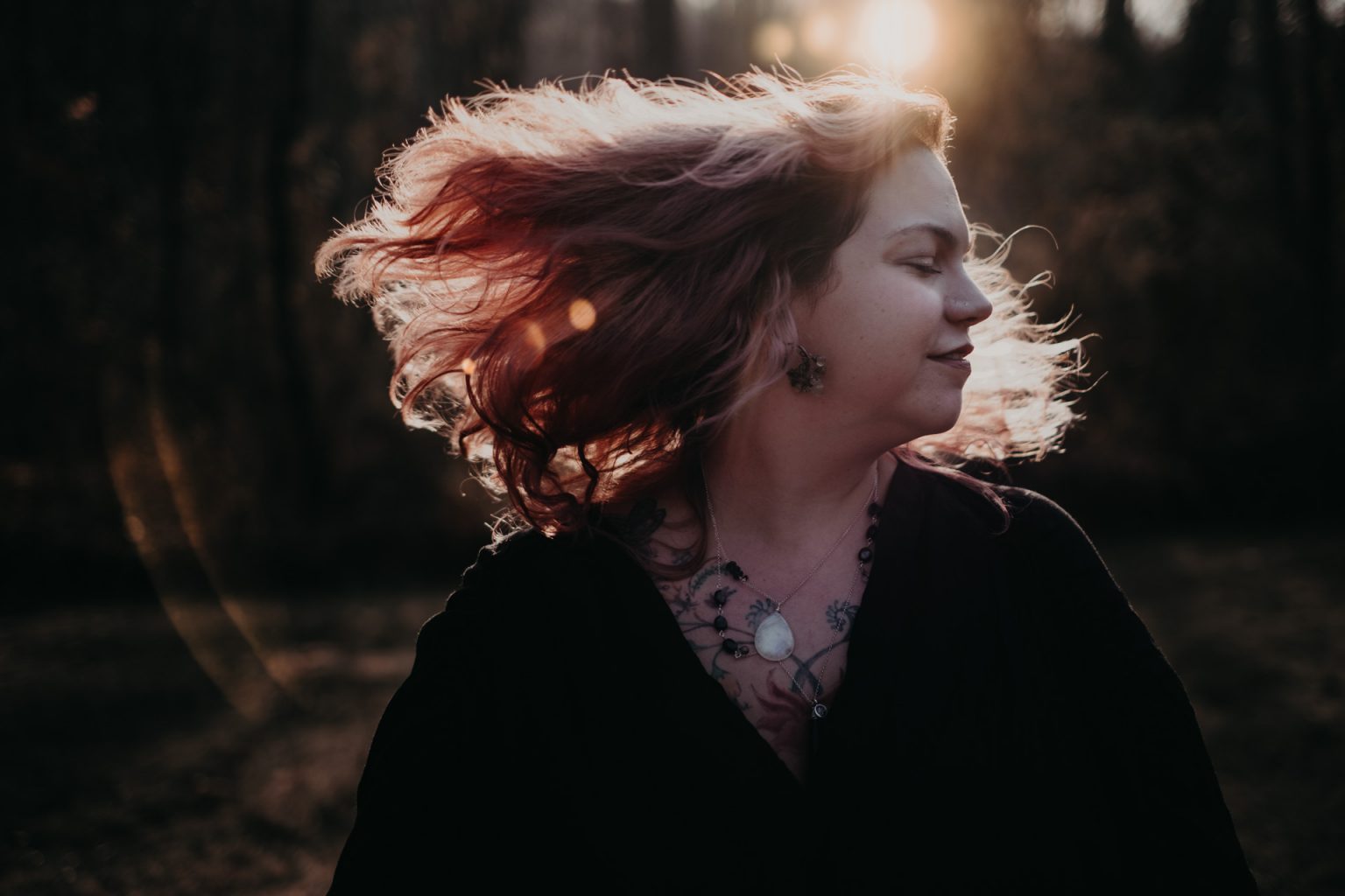  woman in woods pink hair in sunlight
