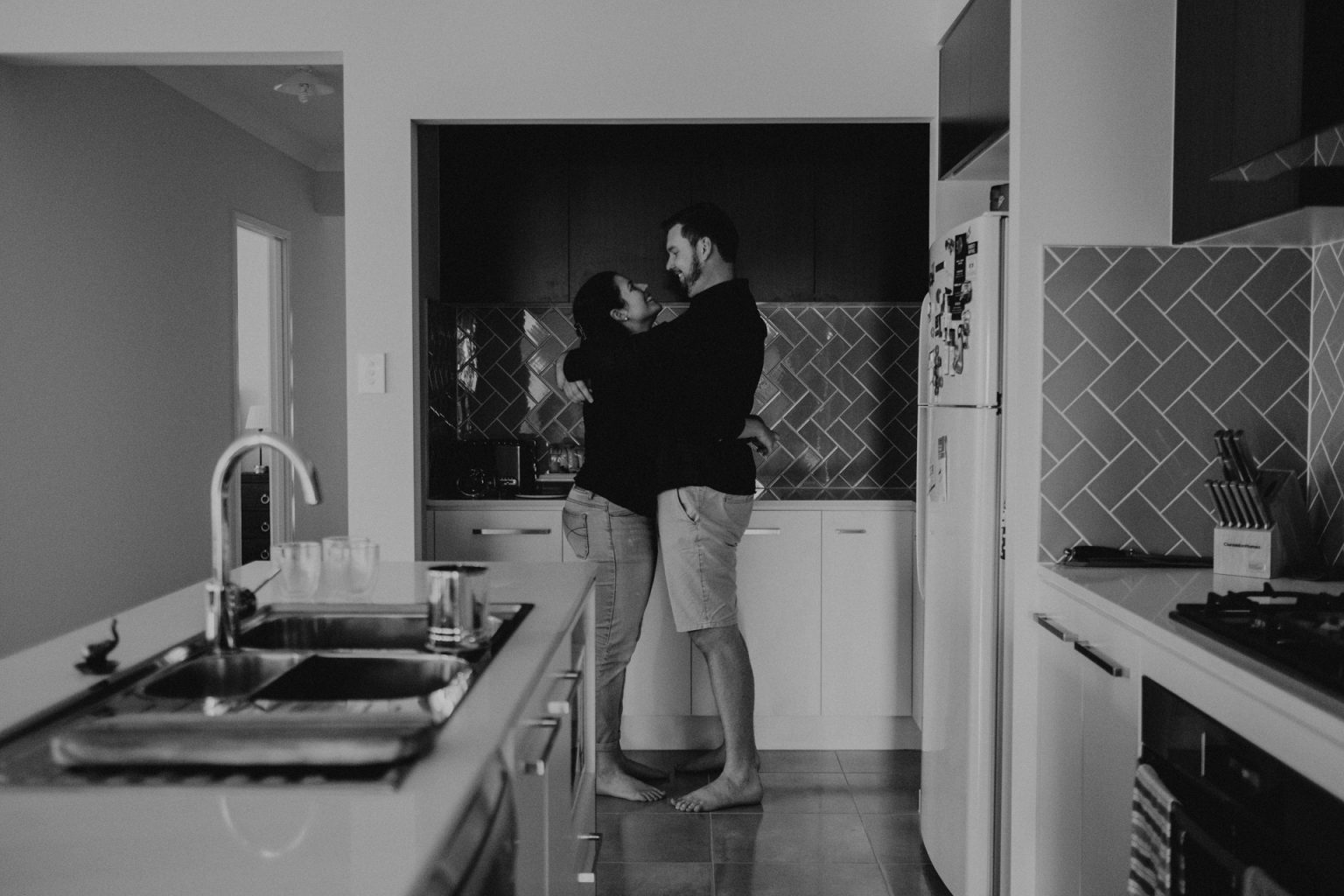 man and woman hugging in kitchen