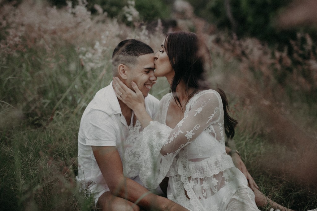 tattooed man and woman wearing lace in field