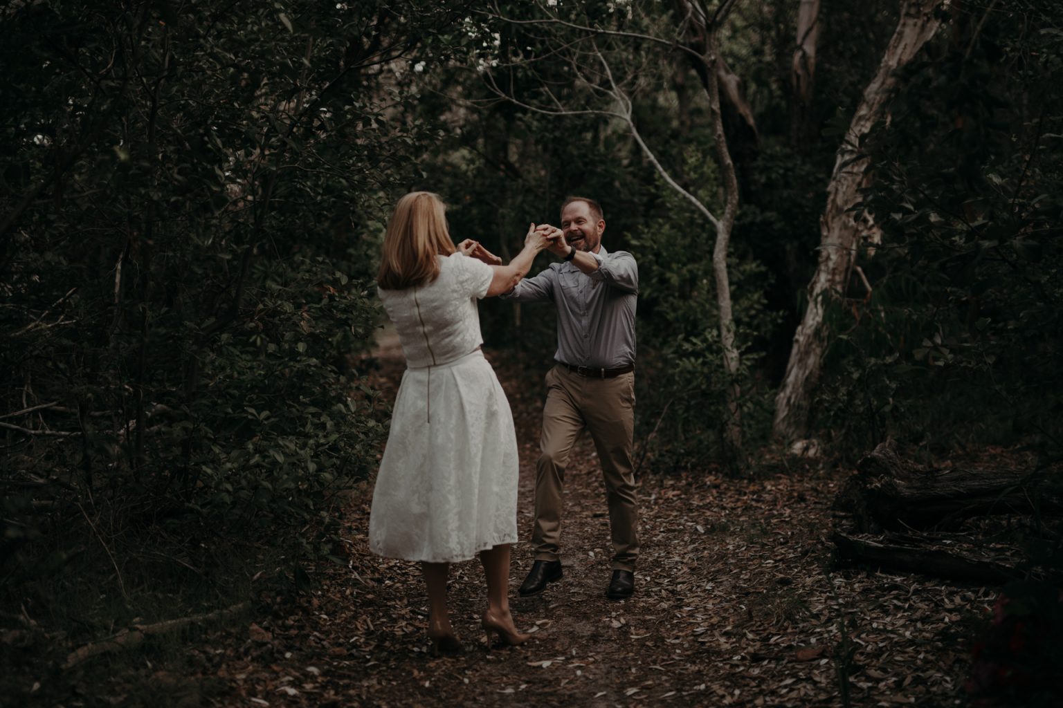 bride and groom dance in forest at Fingal head